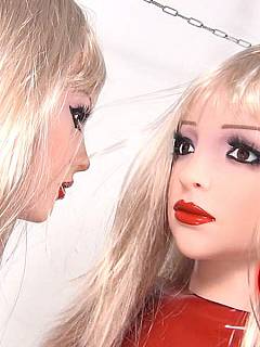 A couple of latex dolls are wearing masks and using dildo to fuck each other