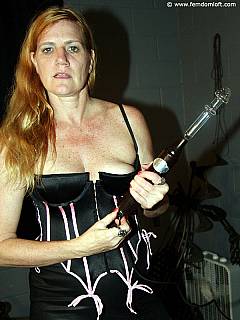 Tall dominatrix is making naked slave suffer by making him wear BDSM harness and take lots of femdom punishments