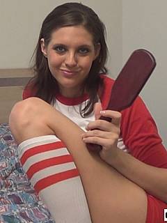 Sporty girl is waiting in her bedroom for willing men to come and receive bare ass leather paddle spanking