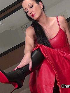 Posh red dress and a pair of high heel leather boots is the perfect outfit for an erotic femdom session
